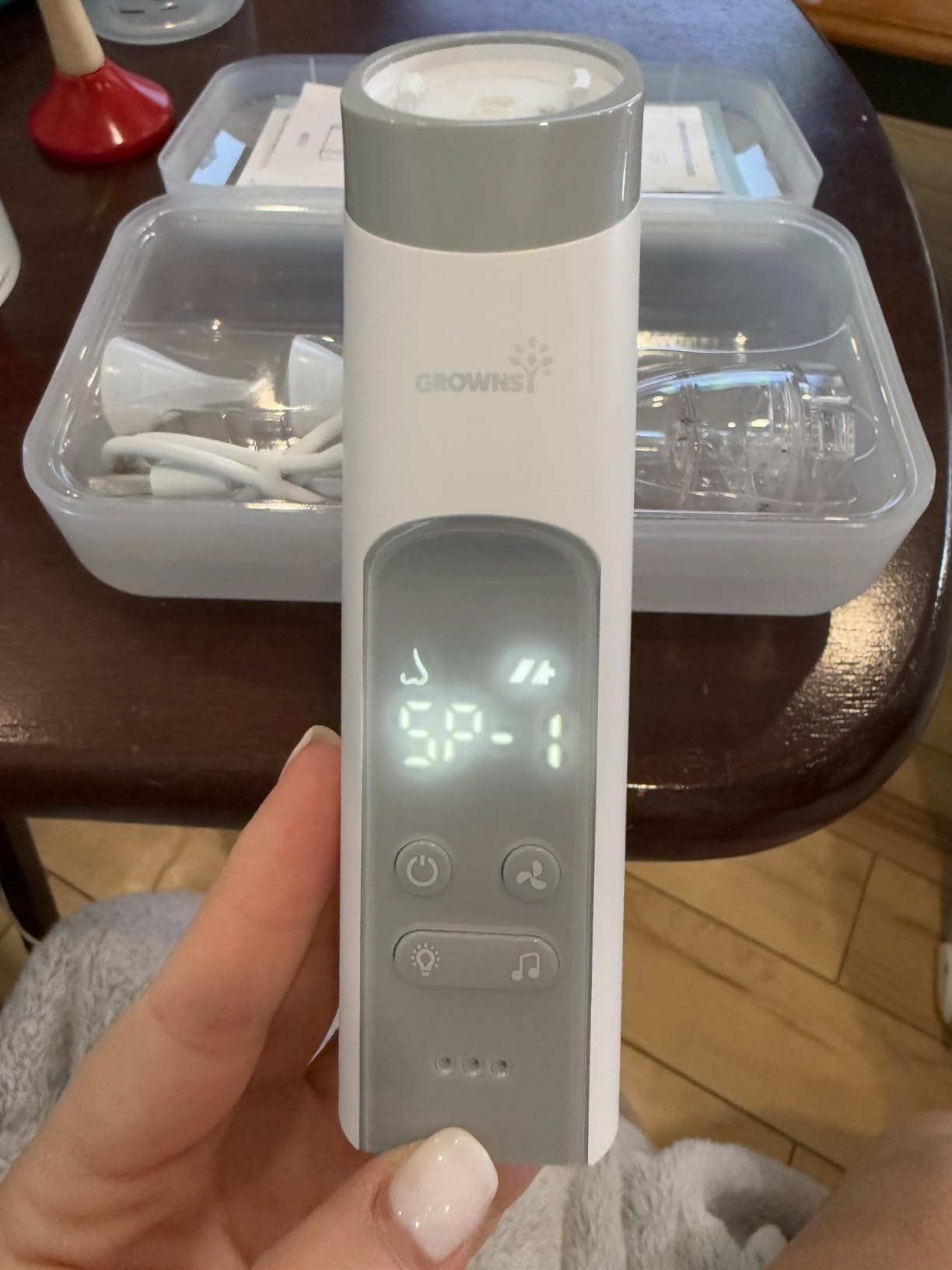 Grownsy nasal aspirator held in hand showing SP-1 mode on the display